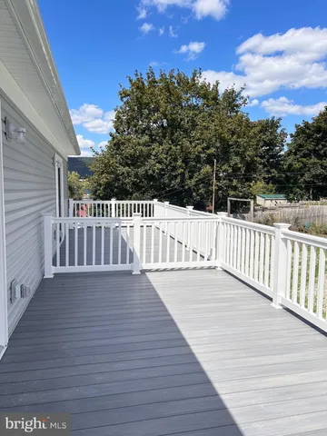 a view of deck with wooden floor and fence