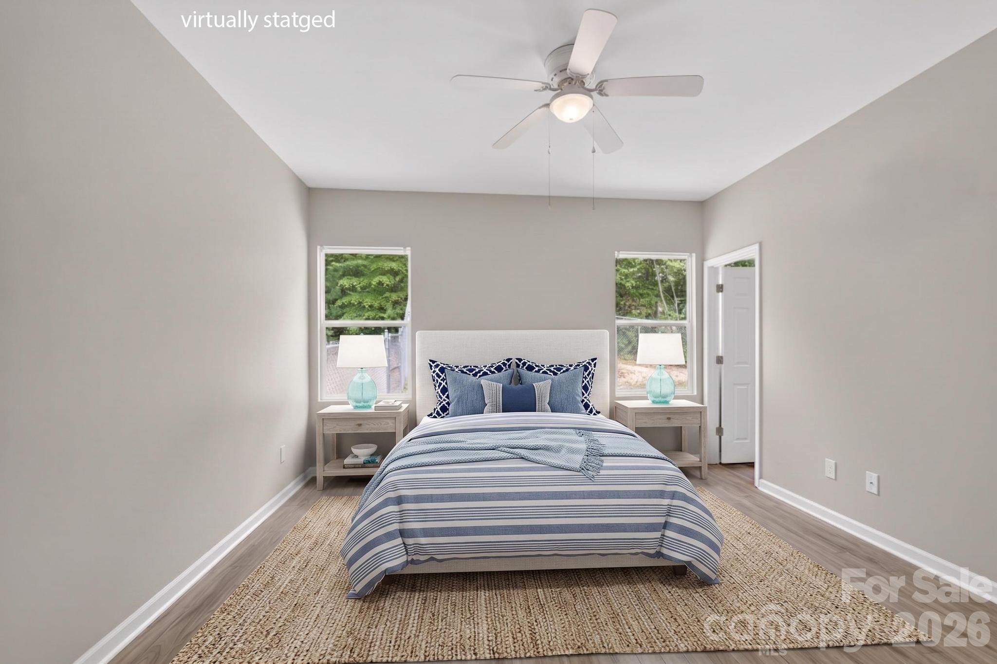 2119 South Road Morganton, NC 28655 - Photo 25 of 47 a bedroom with a large bed and a chandelier