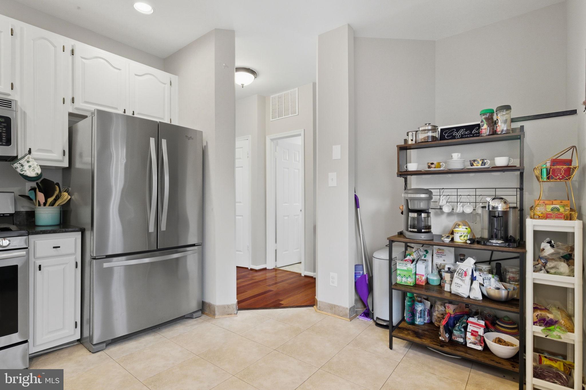 47587 Comer Square Sterling, VA 20165 - Photo 11 of 77 a kitchen with stainless steel appliances a refrigerator and a stove top oven