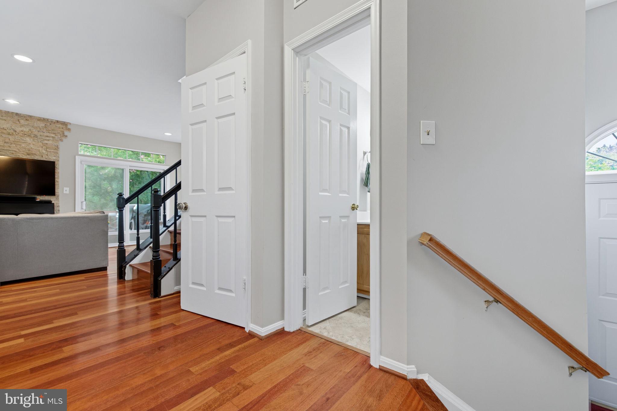 47587 Comer Square Sterling, VA 20165 - Photo 14 of 77 a view of a hallway with wooden floor and staircase