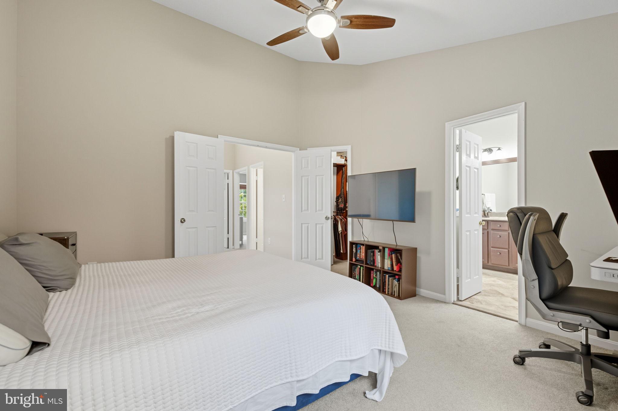 47587 Comer Square Sterling, VA 20165 - Photo 33 of 77 a bedroom with a bed a desk and a chandelier