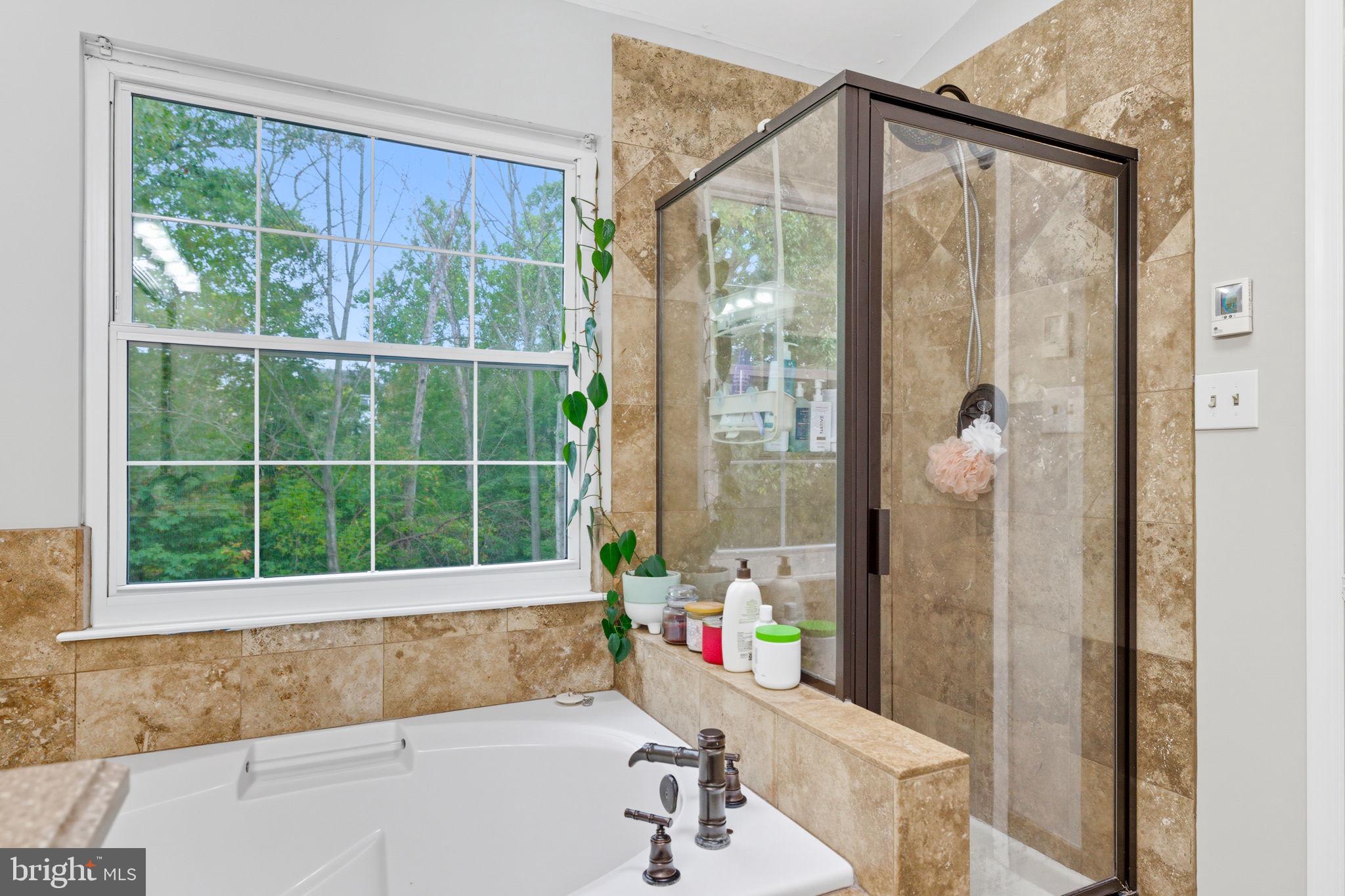47587 Comer Square Sterling, VA 20165 - Photo 38 of 77 a bathroom with a bathtub and a shower
