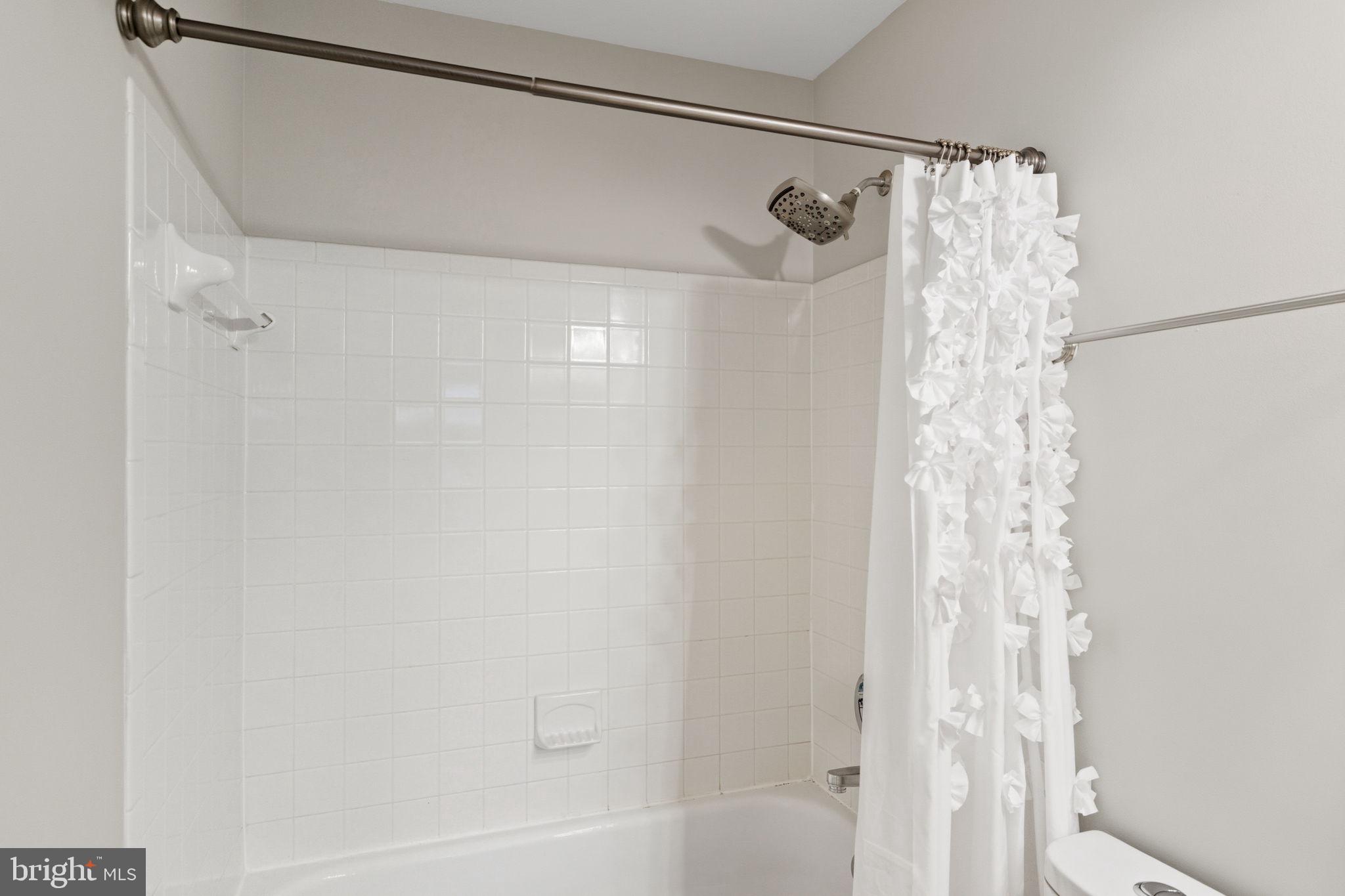 47587 Comer Square Sterling, VA 20165 - Photo 43 of 77 a bathroom with a shower curtain and a shower