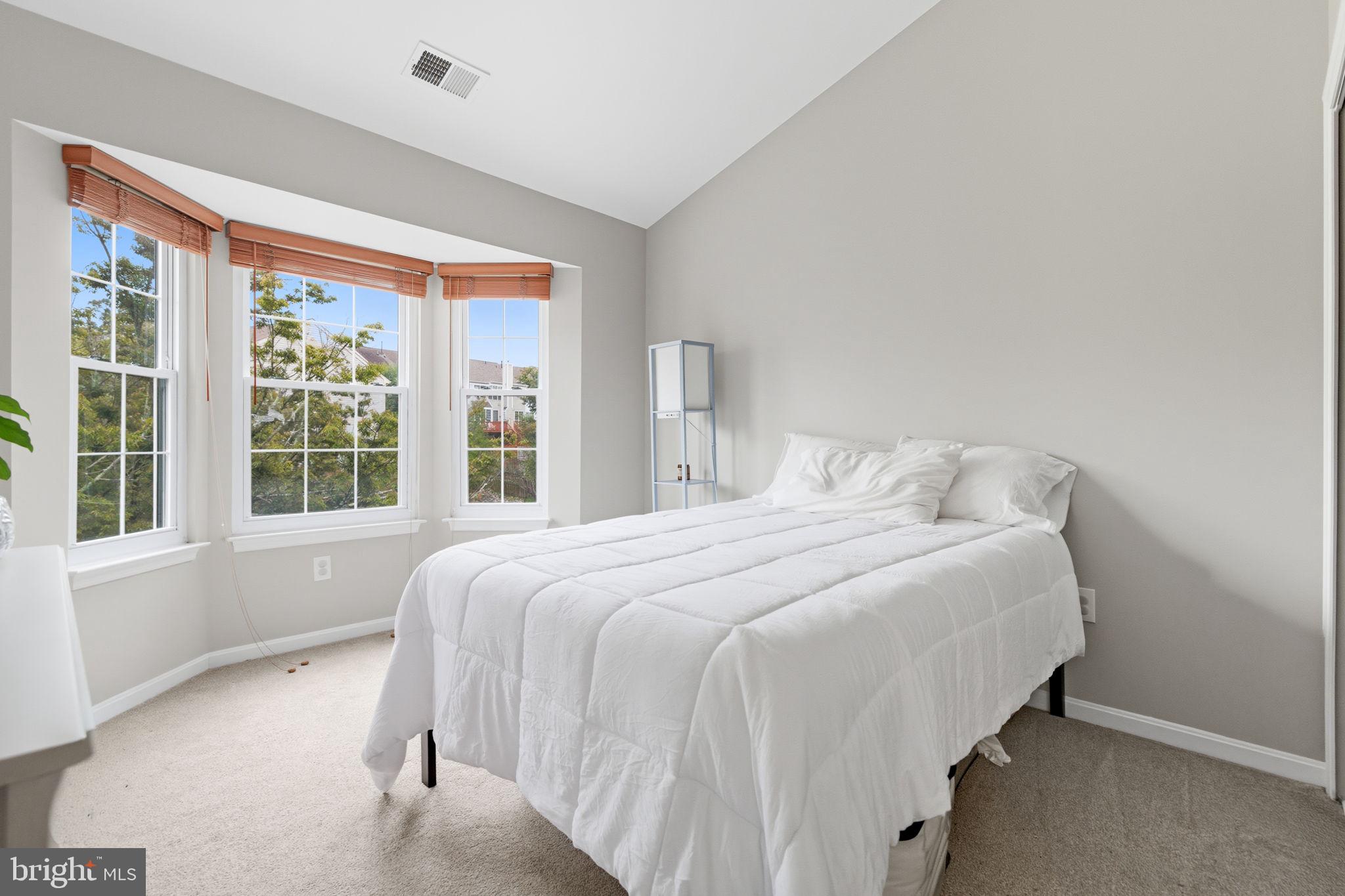 47587 Comer Square Sterling, VA 20165 - Photo 48 of 77 a bedroom with a bed and windows