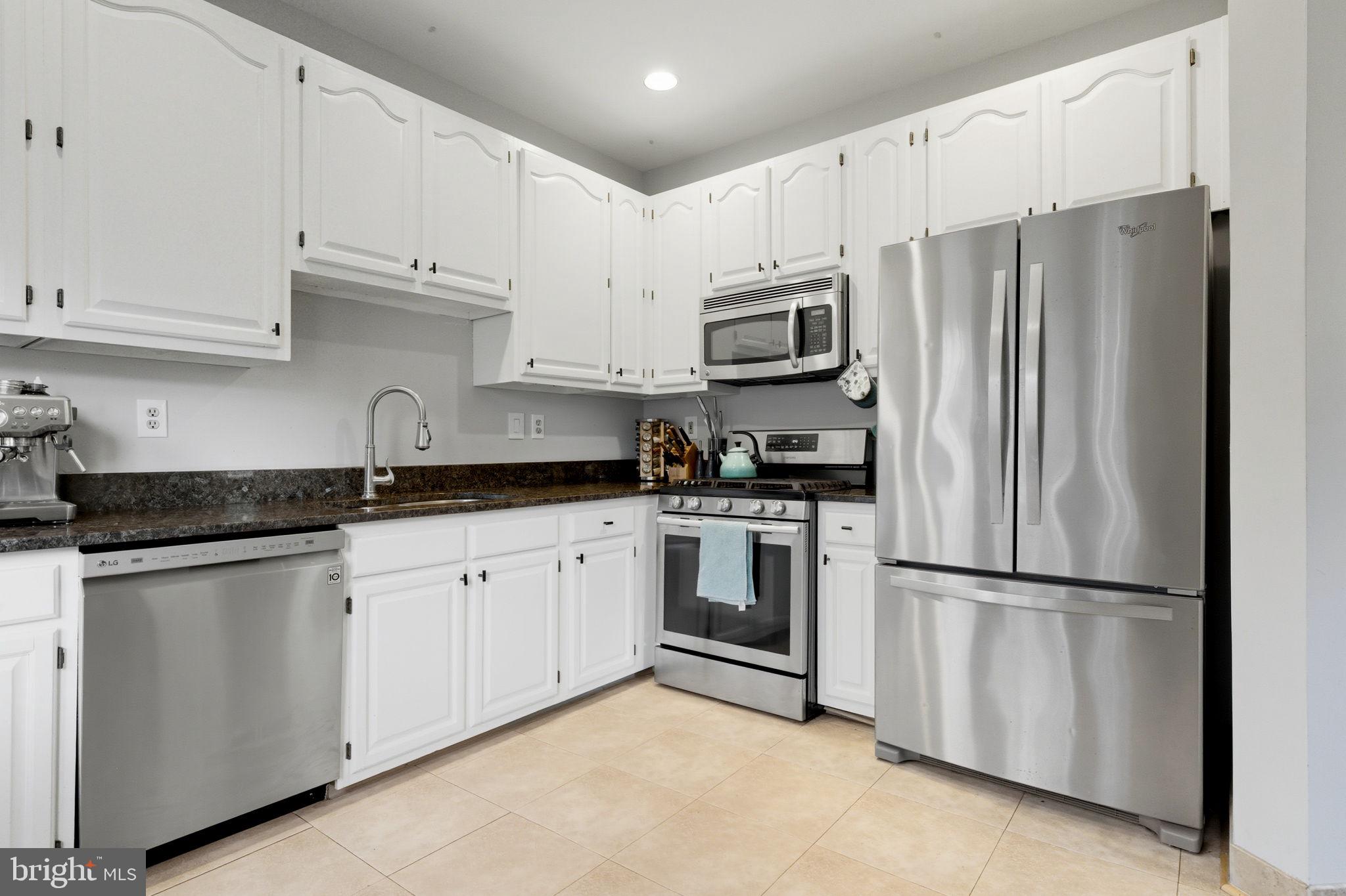 47587 Comer Square Sterling, VA 20165 - Photo 10 of 77 a kitchen with cabinets stainless steel appliances and a counter space