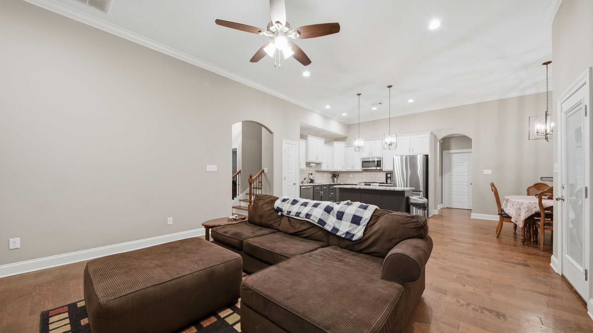70 Trinity Cove Atoka, TN 38004 - Photo 4 of 25 Open-concept living space with wood-finish flooring, crown molding, a ceiling fan, and recessed lighting