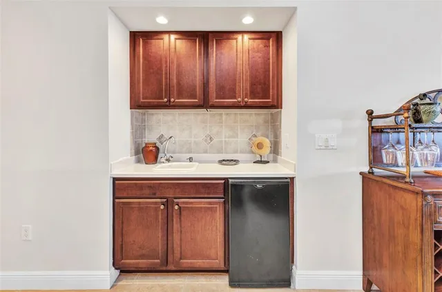 a kitchen with stainless steel appliances kitchen island a table and chairs in it