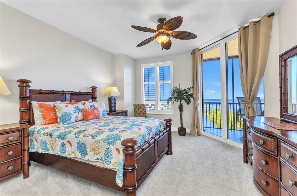 3321 Sunset Key Circle, Unit 502 Punta Gorda, FL 33955 - Photo 12 of 36 a bedroom with a bed and a chandelier