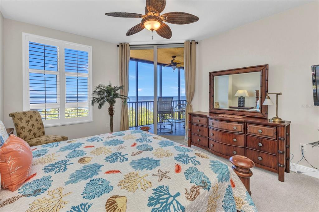 3321 Sunset Key Circle, Unit 502 Punta Gorda, FL 33955 - Photo 14 of 36 a bedroom with a bed and a dresser in it