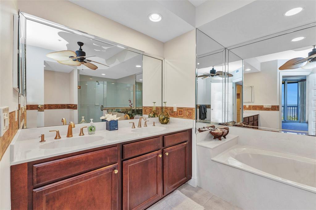 3321 Sunset Key Circle, Unit 502 Punta Gorda, FL 33955 - Photo 17 of 36 a bathroom with a tub a sink double vanity and a mirror