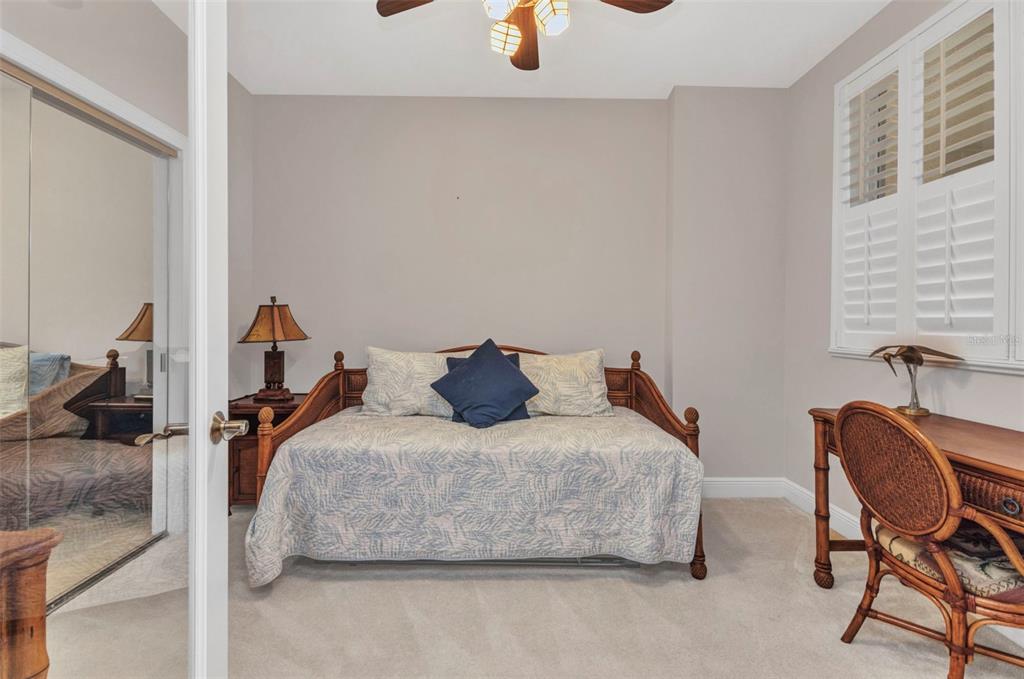3321 Sunset Key Circle, Unit 502 Punta Gorda, FL 33955 - Photo 20 of 36 a bedroom with a bed and chair