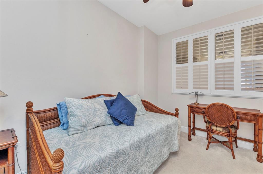 3321 Sunset Key Circle, Unit 502 Punta Gorda, FL 33955 - Photo 21 of 36 a bedroom with a bed and a chair