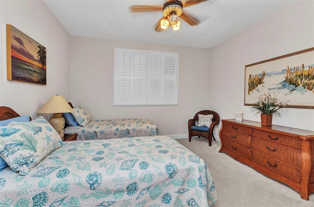 3321 Sunset Key Circle, Unit 502 Punta Gorda, FL 33955 - Photo 22 of 36 a bedroom with a bed and a chandelier