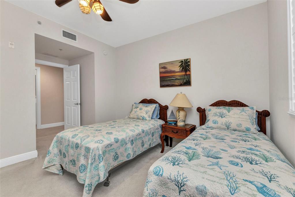 3321 Sunset Key Circle, Unit 502 Punta Gorda, FL 33955 - Photo 23 of 36 a bedroom with two beds and a lamp