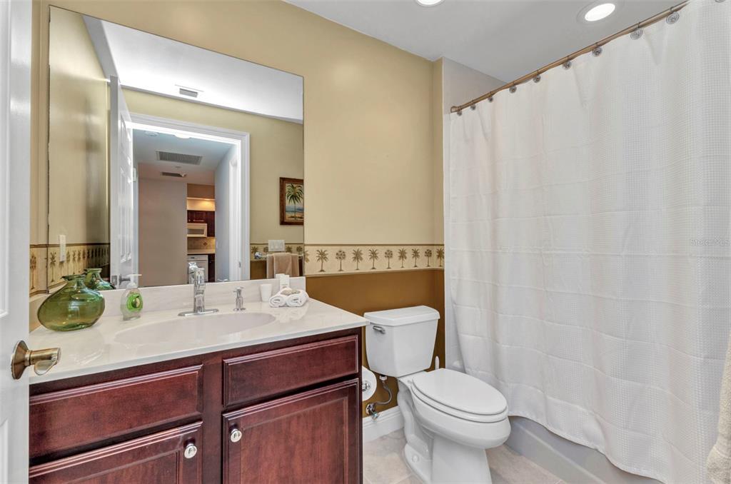 3321 Sunset Key Circle, Unit 502 Punta Gorda, FL 33955 - Photo 24 of 36 a bathroom with a sink a toilet and shower curtain