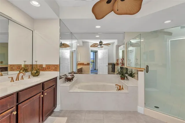 a bathroom with a shower sink vanity and mirror