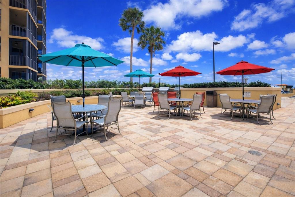3321 Sunset Key Circle, Unit 502 Punta Gorda, FL 33955 - Photo 5 of 36 an outdoor space with patio furniture and umbrella