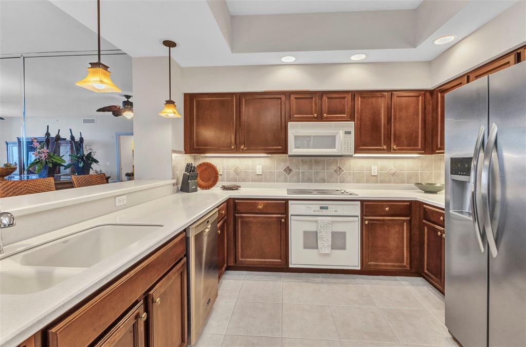 3321 Sunset Key Circle, Unit 502 Punta Gorda, FL 33955 - Photo 9 of 36 a kitchen with stainless steel appliances granite countertop a sink a stove and a refrigerator