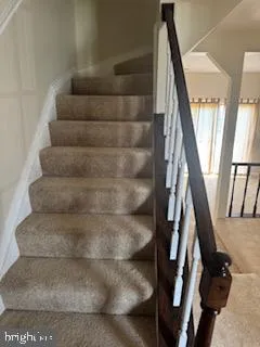 a view of staircase with white walls