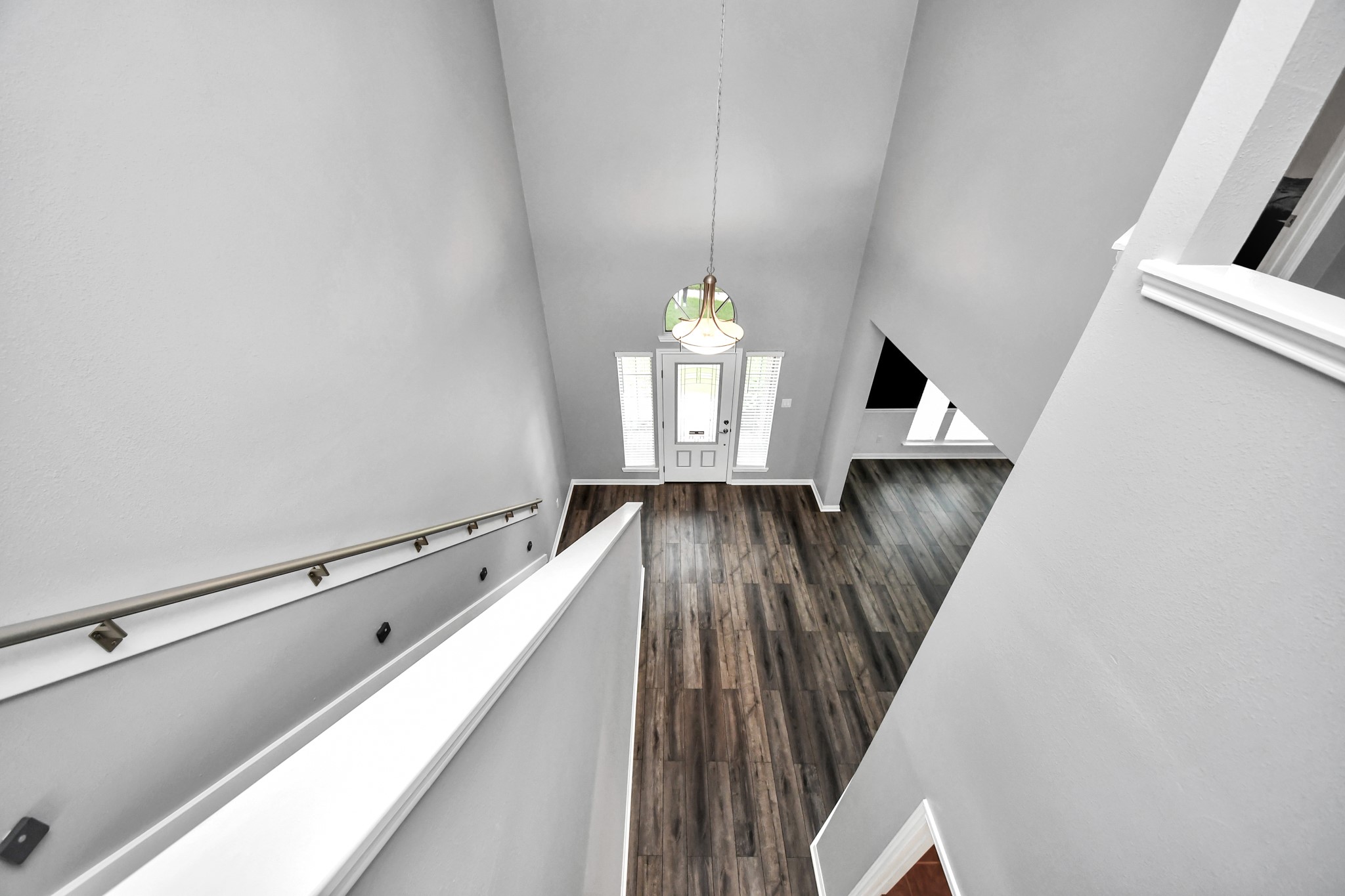 7622 McCormick Mill Court Houston, TX 77095 - Photo 15 of 37 a hallway with windows and wooden floor