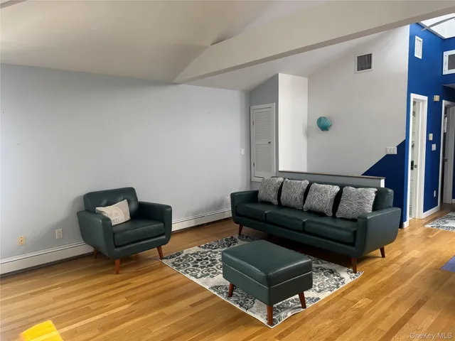 a living room with furniture and a rug