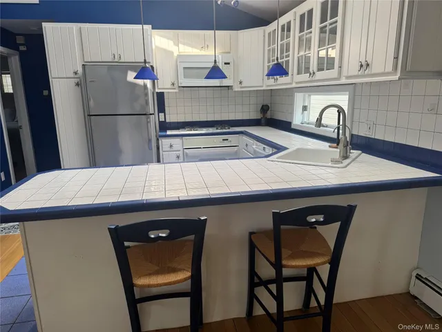 a kitchen with stainless steel appliances a sink cabinets and a refrigerator