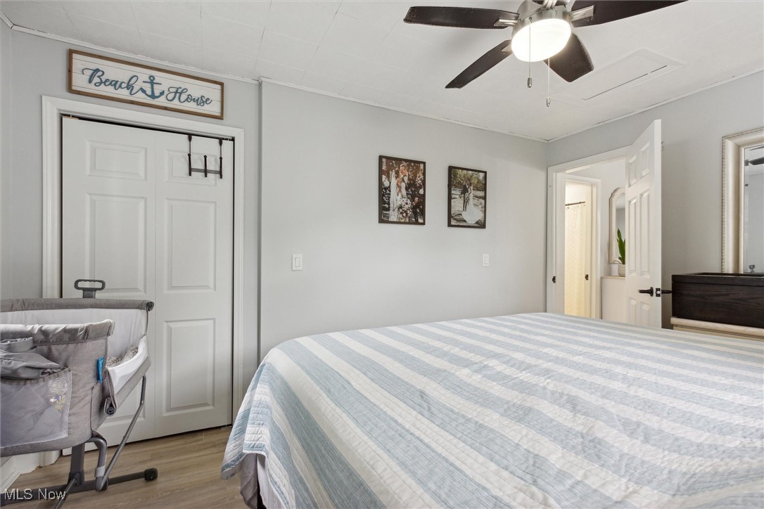 373 Erie Road Vermilion, OH 44089 - Photo 18 of 29 Bedroom featuring light hardwood / wood-style floors, ceiling fan, and a closet