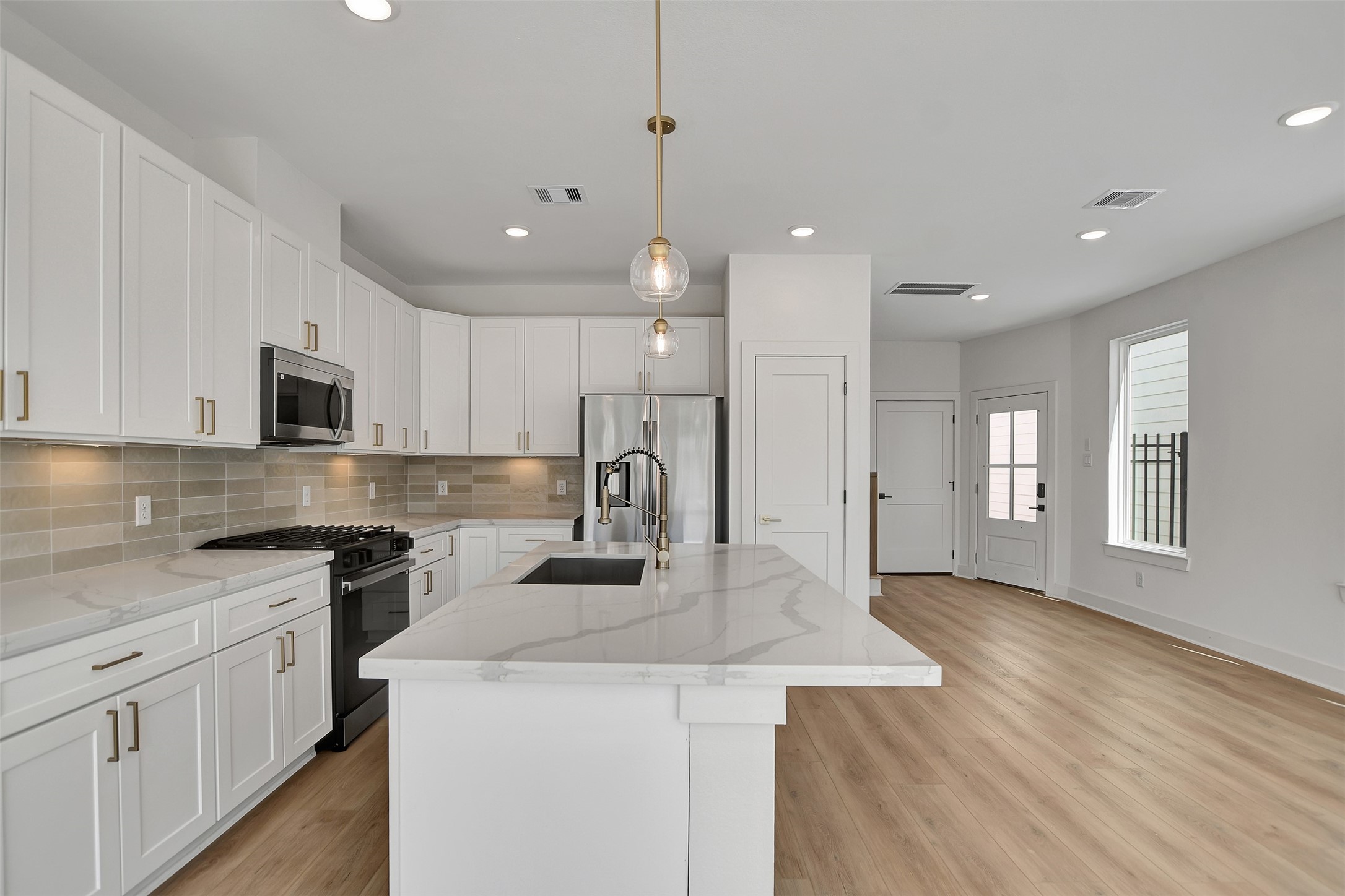 3626 Amos Street Houston, TX 77021 - Photo 12 of 43 a kitchen with kitchen island a white counter top space stainless steel appliances and cabinets