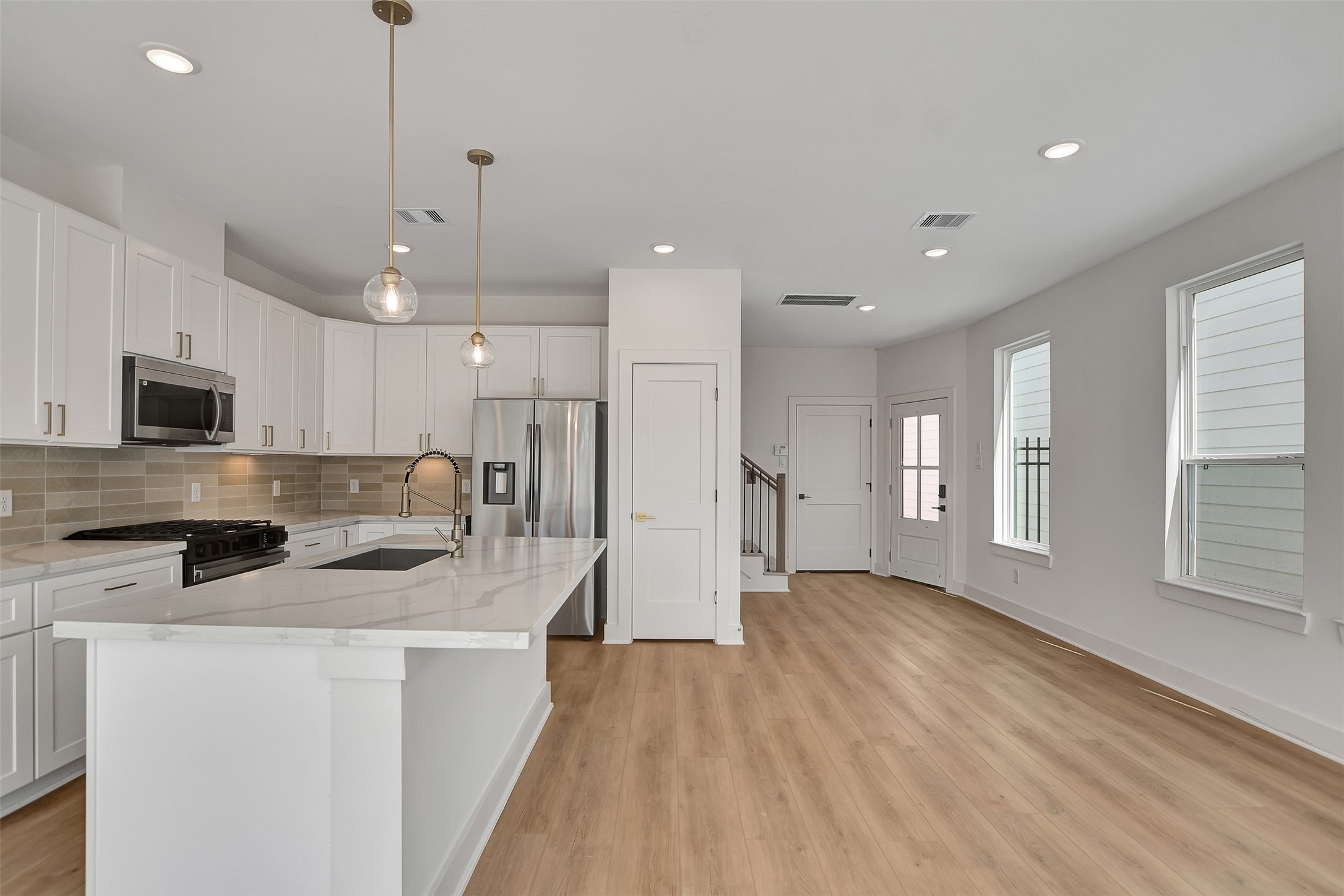 3626 Amos Street Houston, TX 77021 - Photo 16 of 43 a kitchen with stainless steel appliances granite countertop a refrigerator a sink dishwasher a stove and white countertops with wooden floor