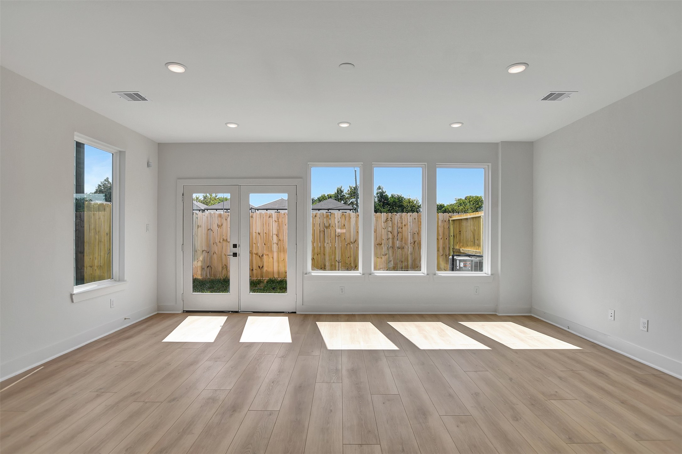 3626 Amos Street Houston, TX 77021 - Photo 18 of 43 an empty room with wooden floor and windows