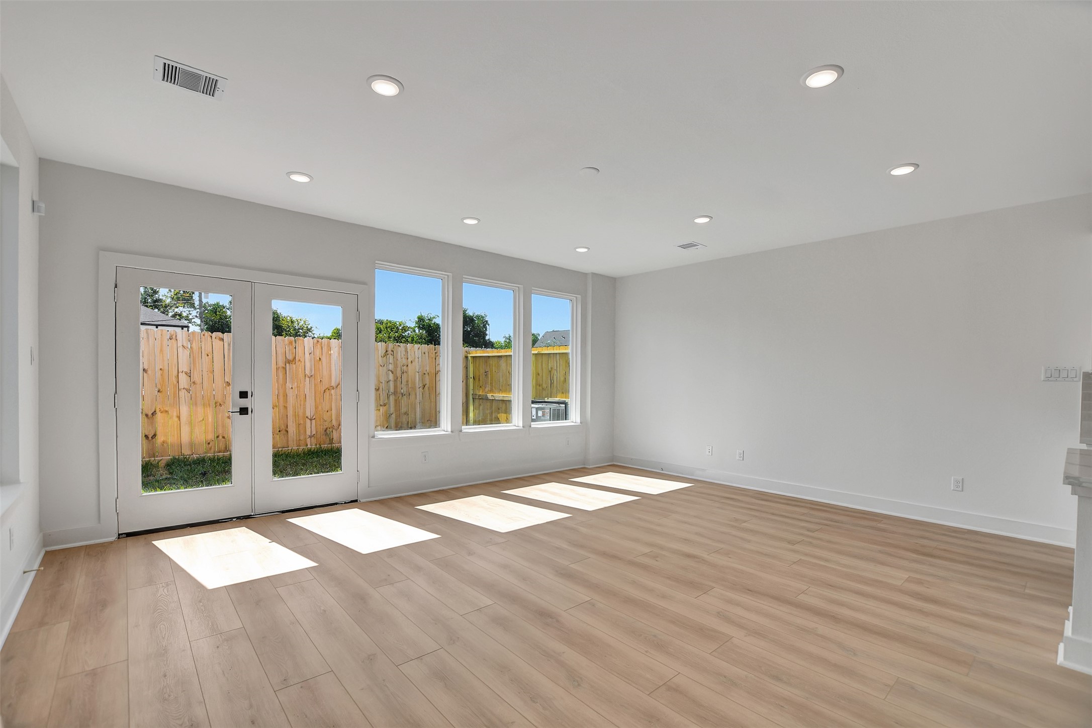 3626 Amos Street Houston, TX 77021 - Photo 19 of 43 a view of an empty room with wooden floor and a window