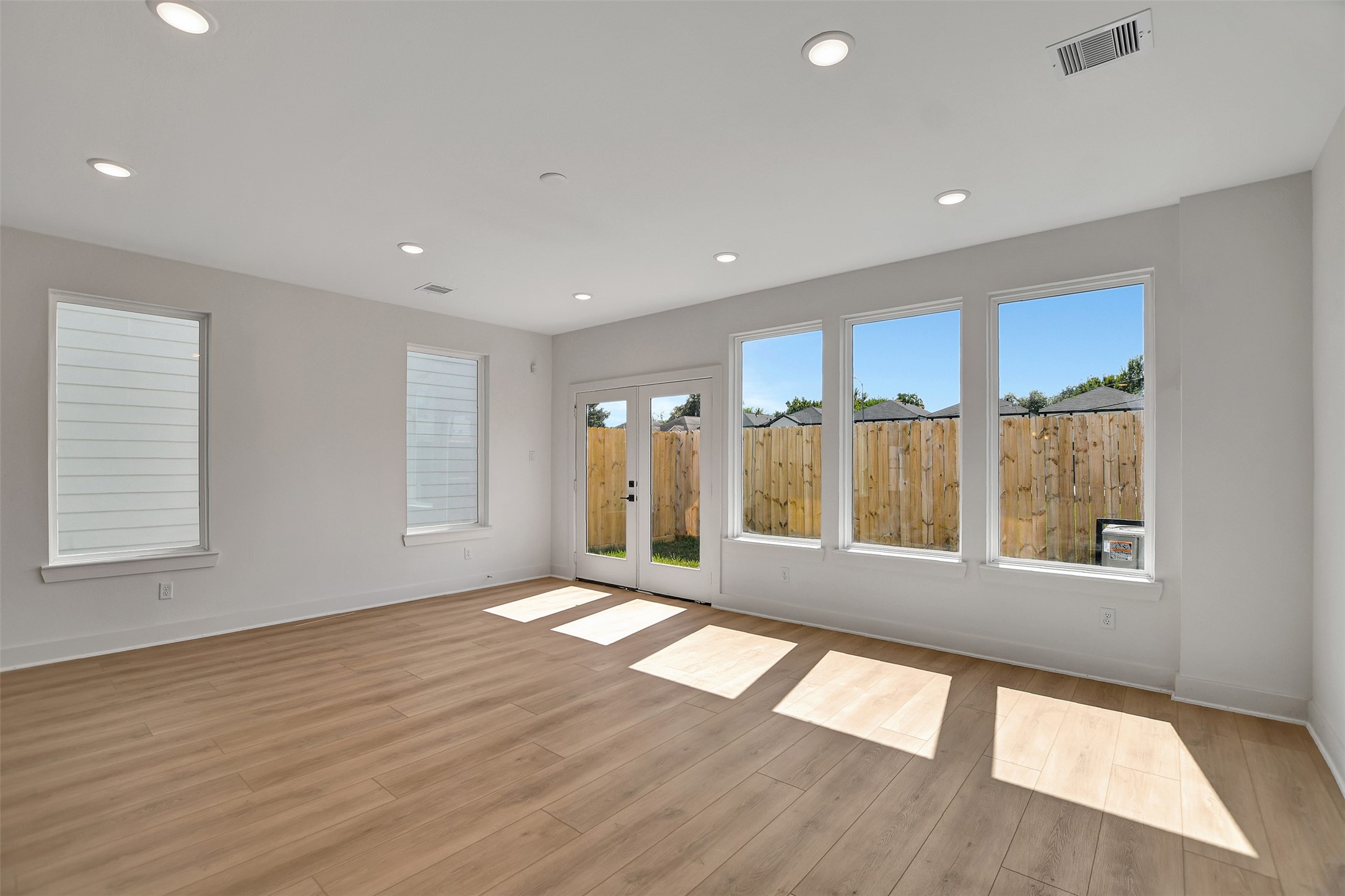3626 Amos Street Houston, TX 77021 - Photo 20 of 43 a view of an empty room with a window and wooden floor