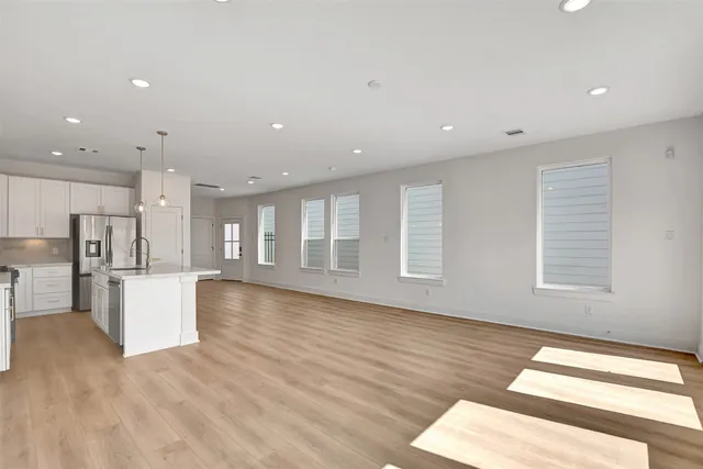 a view of kitchen with refrigerator and window