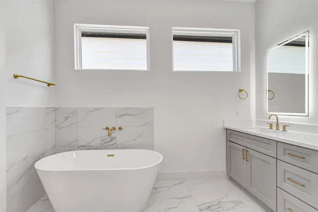 a white bath tub sitting next to a white sink