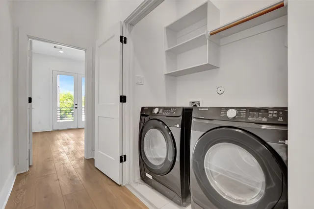 a view of a hallway with washer and dryer