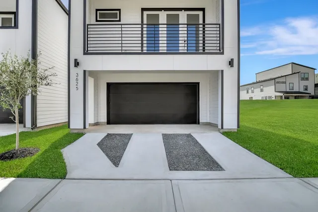 a view of backyard of house and garage
