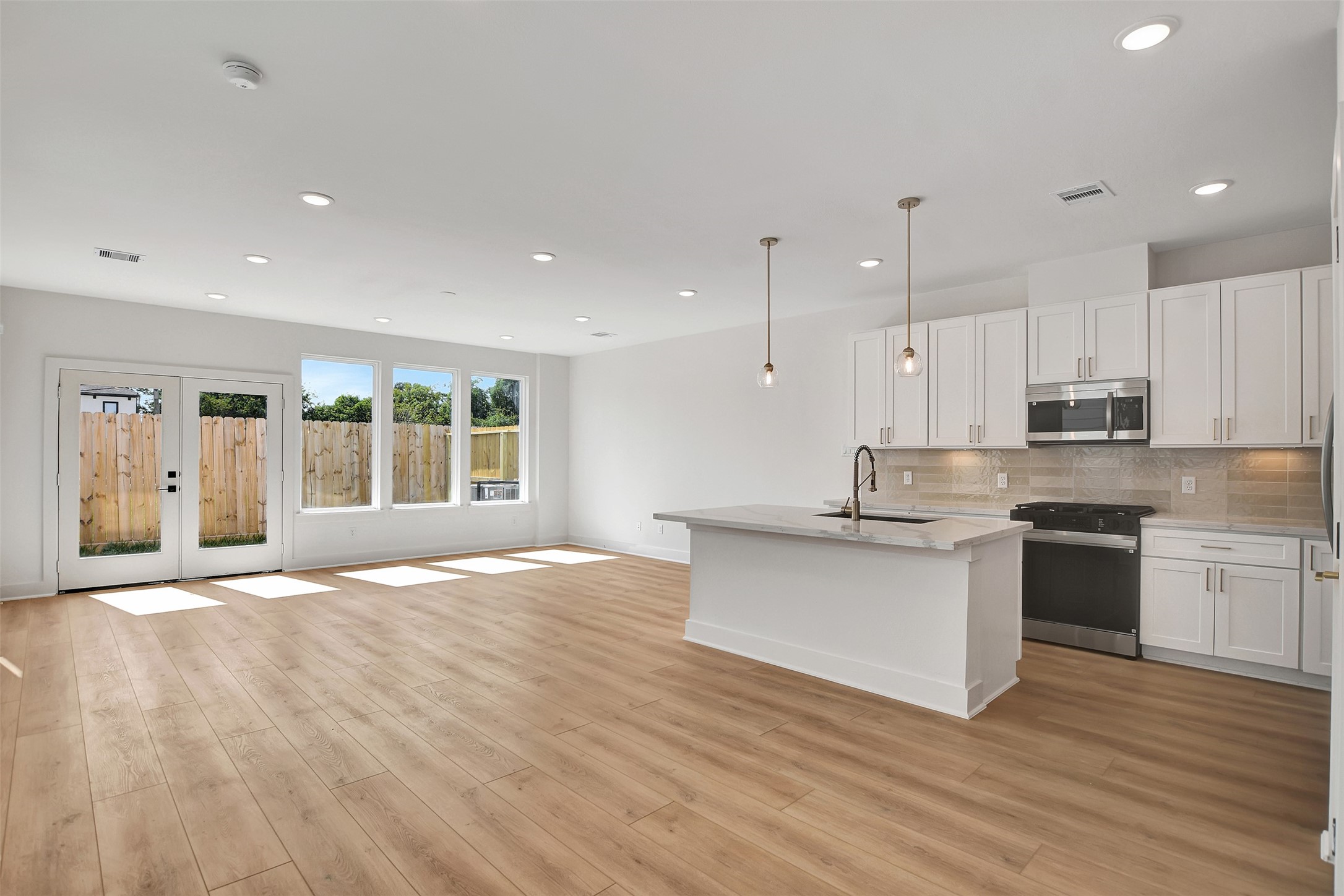 3626 Amos Street Houston, TX 77021 - Photo 9 of 43 a large kitchen with granite countertop a stove top oven a sink a counter space and wooden floor