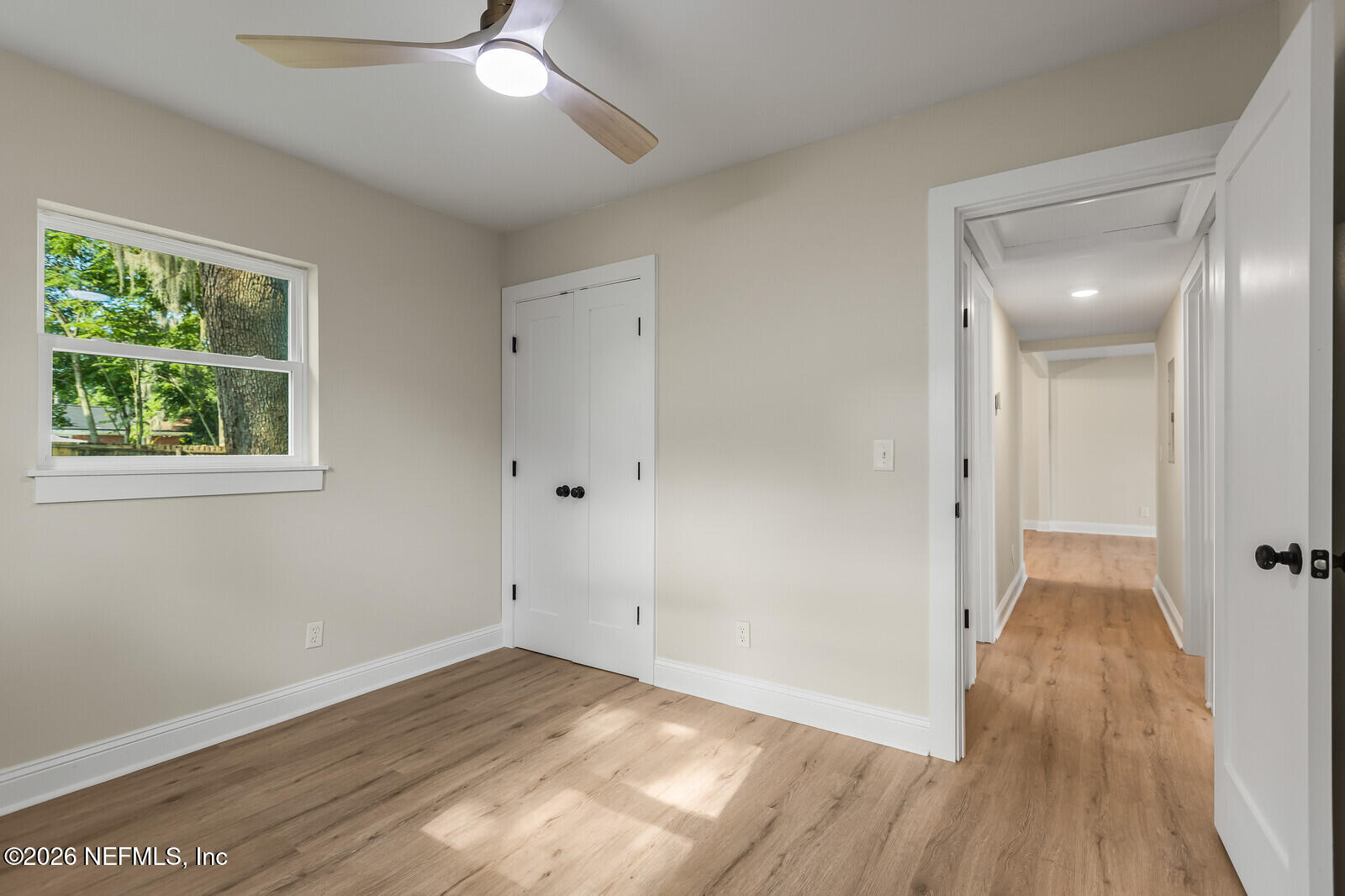 2614 Leonid Road Jacksonville, FL 32218 - Photo 19 of 24 an empty room with wooden floor and windows