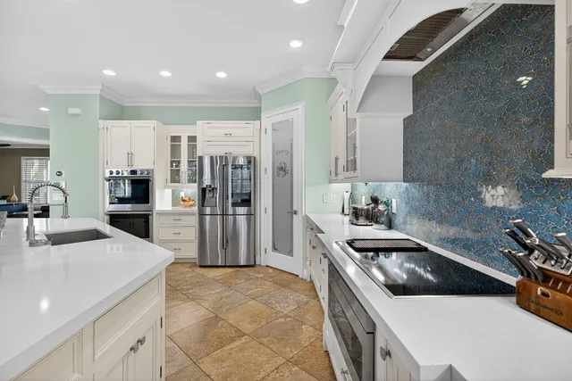 a kitchen with a sink stainless steel appliances and cabinets