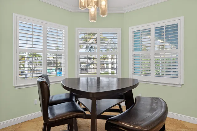 a dining room with furniture a chandelier and wooden floor
