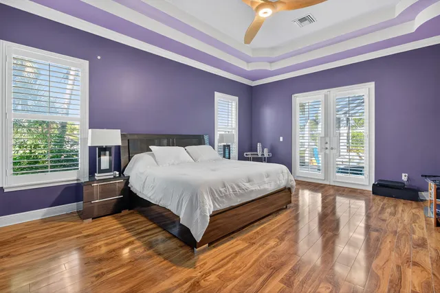 a large bed sitting in a bedroom next to a window