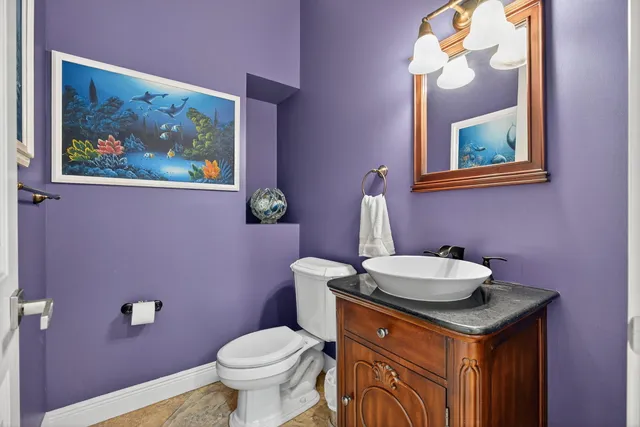 a bathroom with a sink a toilet and mirror