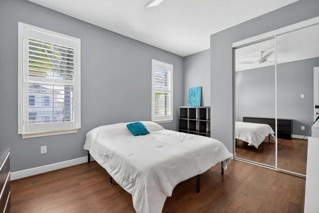 a bedroom with a bed and wooden floor