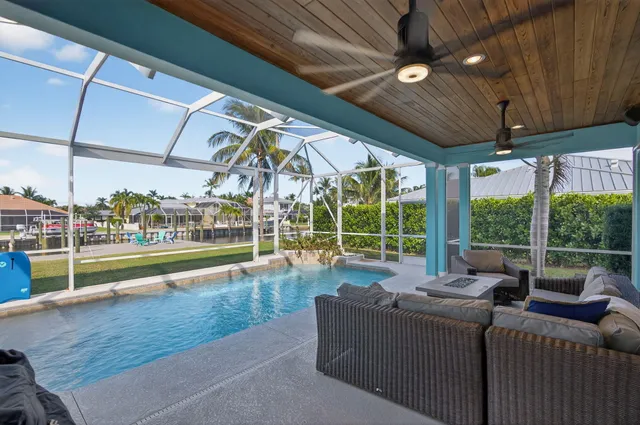 a living room with furniture and a floor to ceiling window