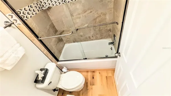 a bathroom with a toilet and a mirror