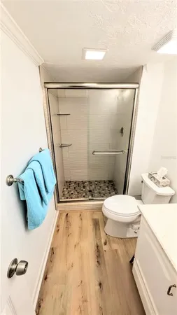 a bathroom with a toilet and a shower