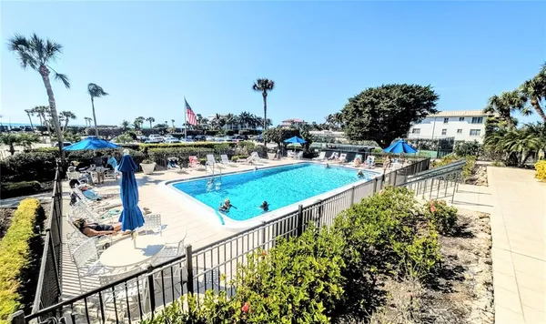 a view of a swimming pool with a table and chairs