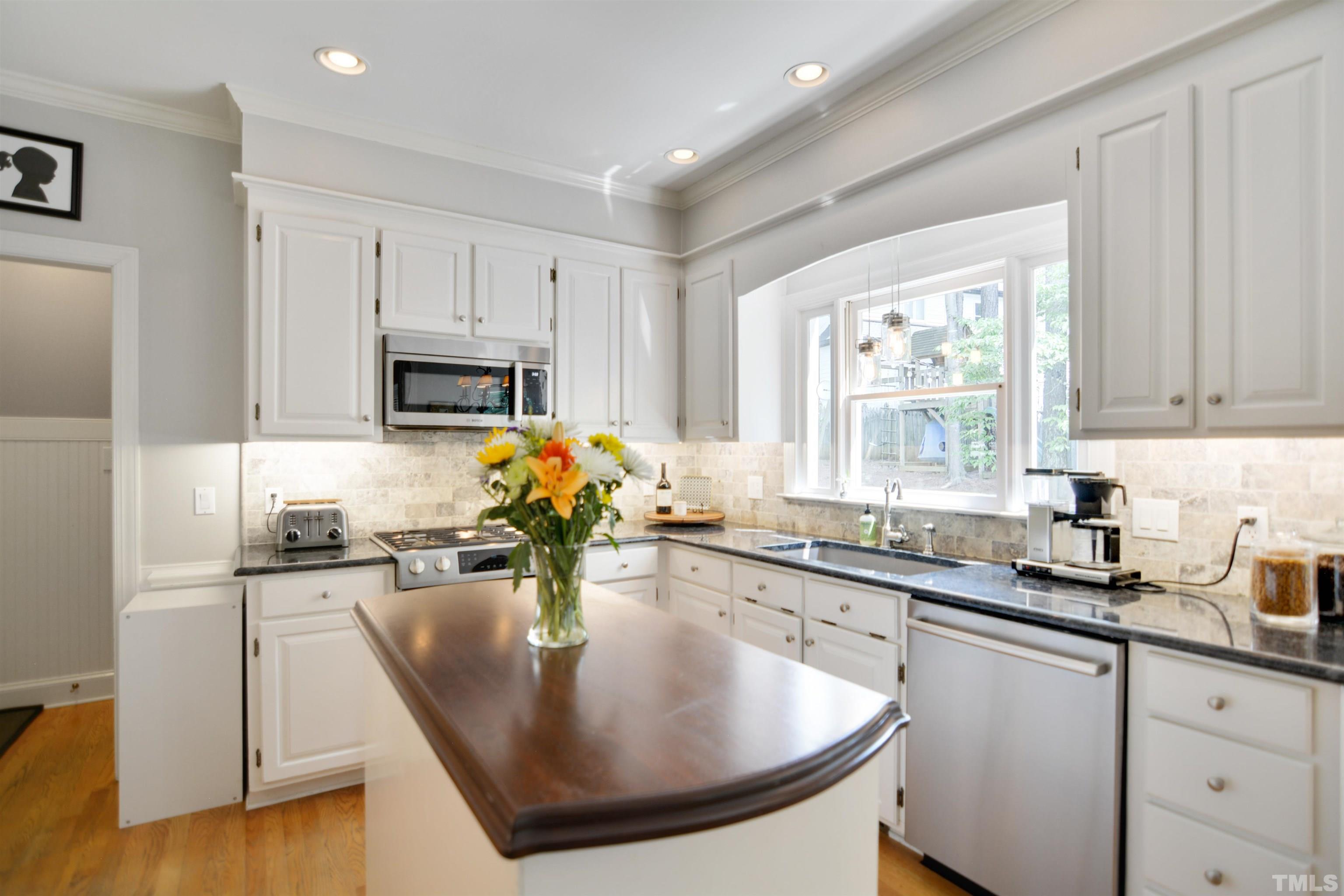 3005 Dunkirk Drive Raleigh, NC 27613 - Photo 11 of 35 a kitchen with sink a window and chairs