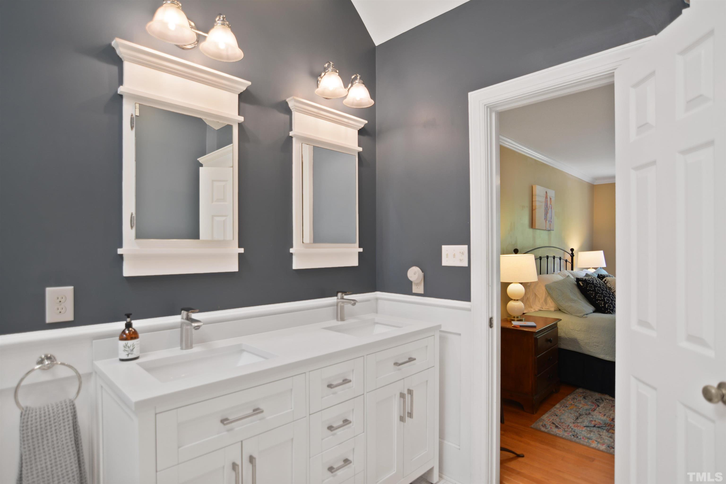 3005 Dunkirk Drive Raleigh, NC 27613 - Photo 18 of 35 a en suite bathroom with a double vanity sink and a mirror