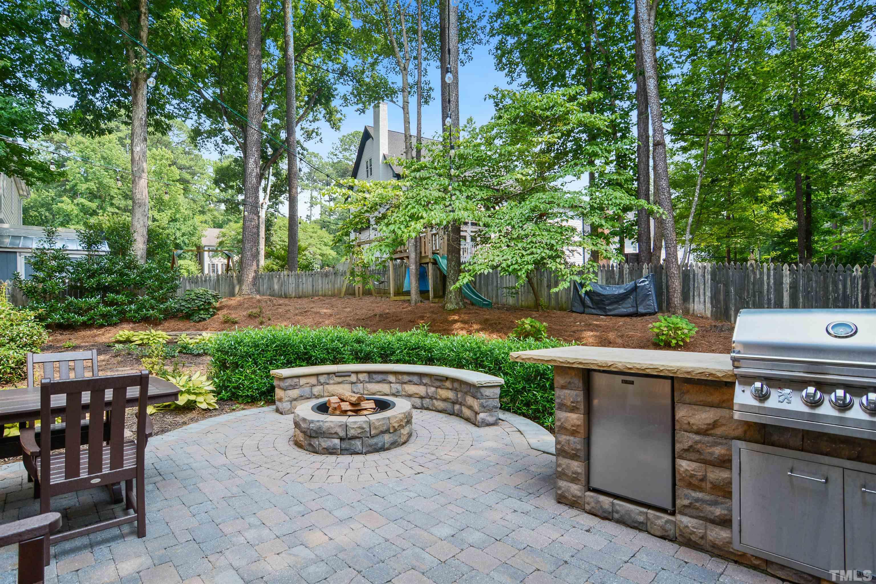 3005 Dunkirk Drive Raleigh, NC 27613 - Photo 31 of 35 a view of a patio with table and chairs potted plants and large tree